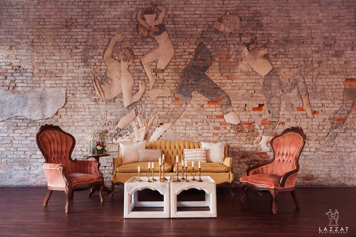 furniture in front of brick wall art at 5 Eleven Palafox