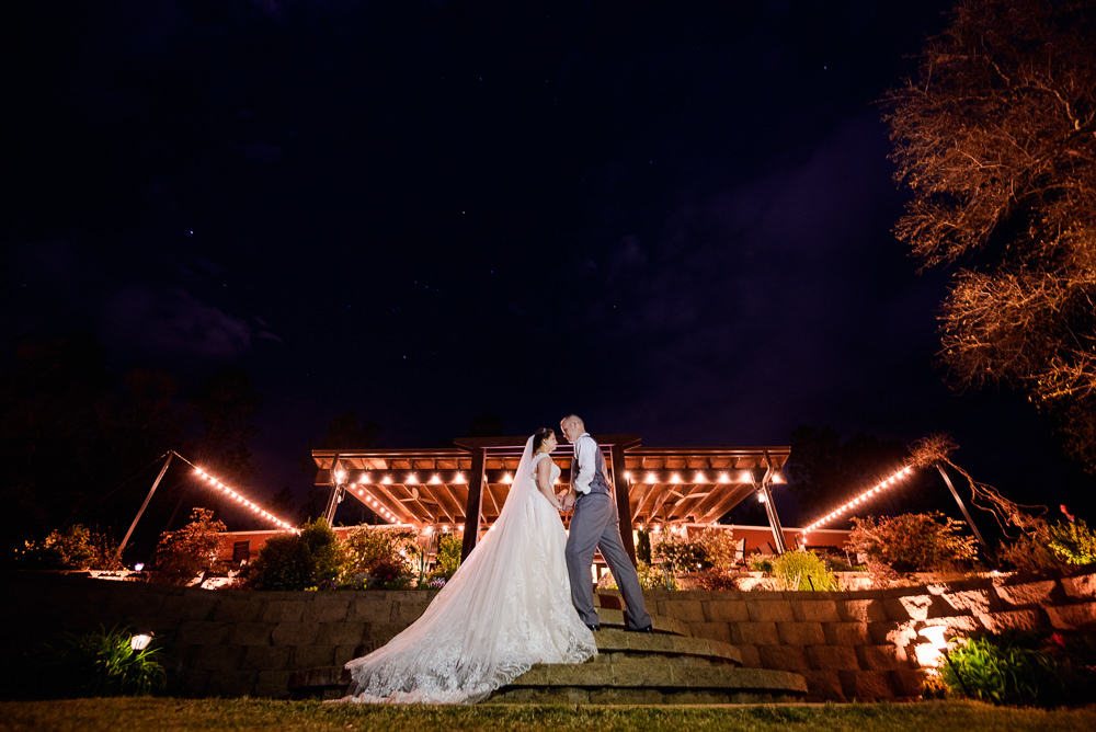 Bride and Groom in front of their venue at night, Coldwater Gardens, Rustic Fairy Tale Wedding, Lazzat Photography