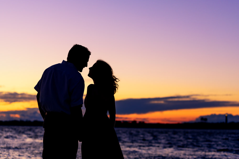 Silhouette of couple by the ocean at sunset, Fun Engagement Session at Eden Garden and Fort Pickens, Lazzat Photography, engagement photos