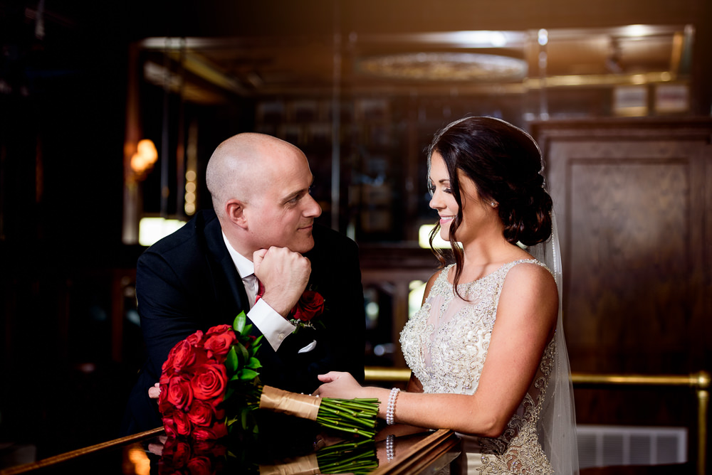 Groom looking at his Bride at The Pensacola Grand Hotel, Classic Red and White Wedding, Lazzat Photography