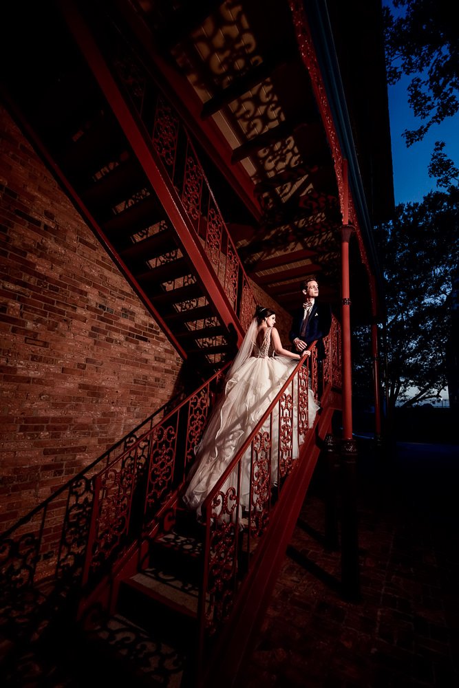 Bride and Groom looking out on the red stairs, Romantic Catholic Wedding, Pensacola Florida Wedding Photographer, Lazzat Photography