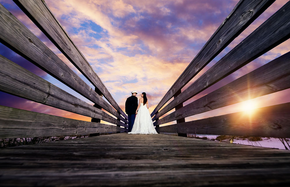 Bride and Groom looking at each other on the pier at sunset, Pensacola Beach Military Wedding, Hilton Pensacola Beach, Lazzat Photography, Florida Wedding Photography