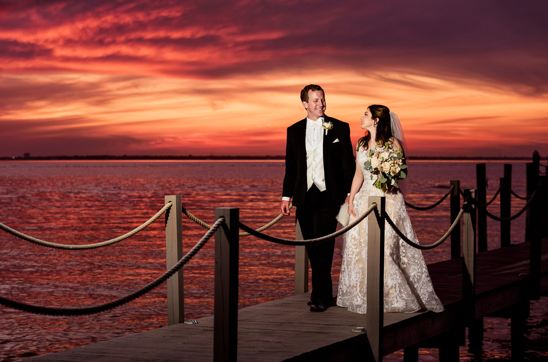 Bride and Groom walking on the pier at sunset, sunset wedding photos, Destin Bay House Wedding, Destin Florida, Lazzat Photography, Florida wedding photographer, Orlando wedding photographer