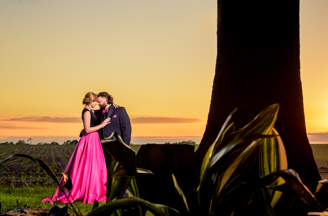 Couple head to head at sunset, hot pink and black outfits, 70’s and 80’s Themed Engagement Session, Coldwater Gardens, Florida engagement photographer, Orlando engagement photographer, Lazzat Photography